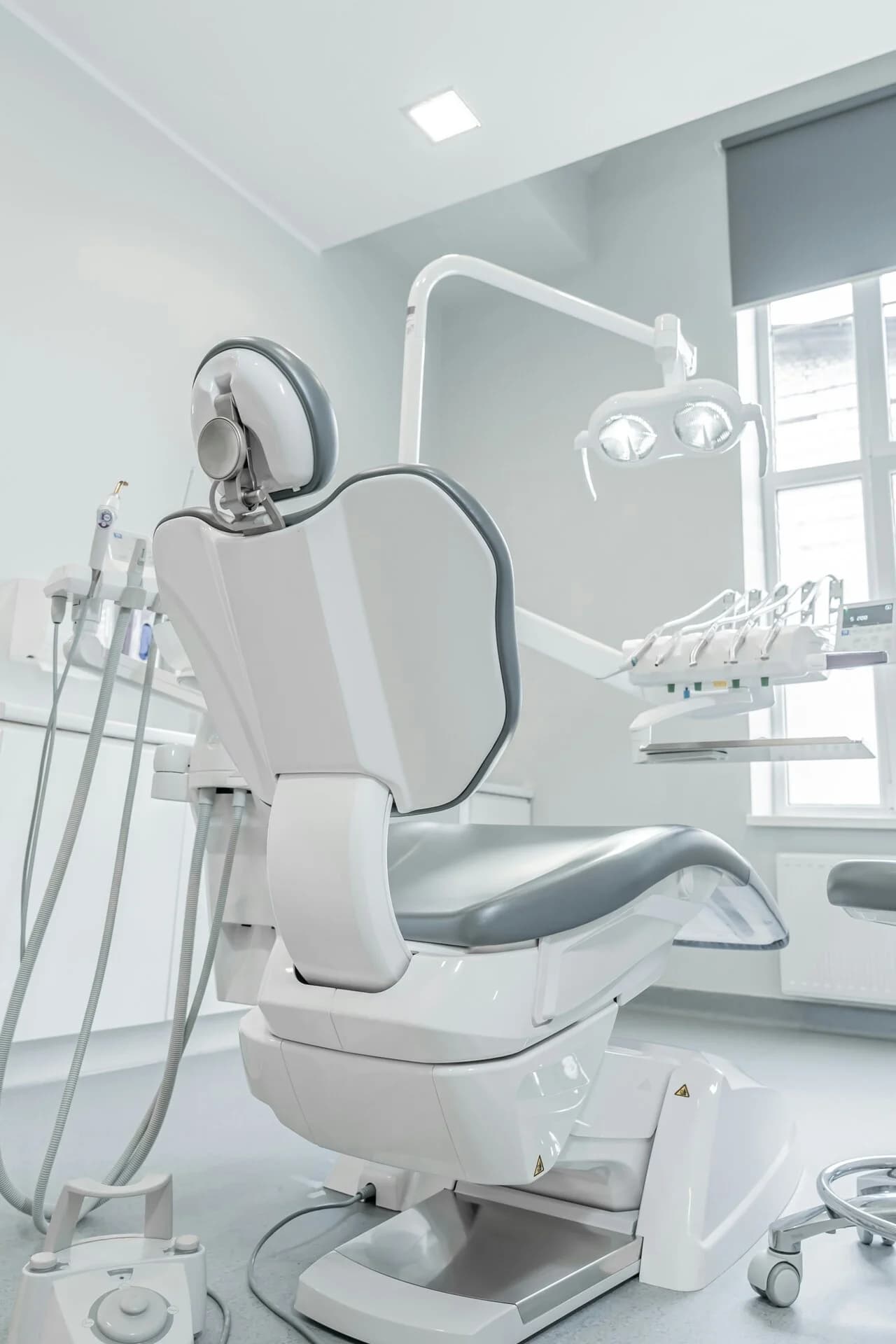 An empty treatment chair in a bright clinic room
