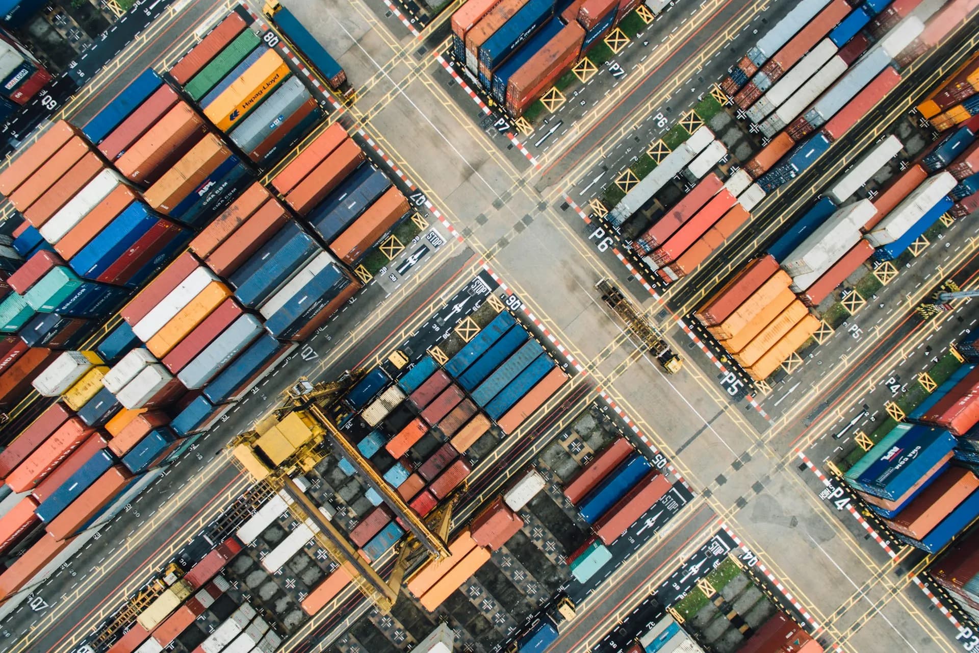 An aerial view of stacked shipping containers at a port