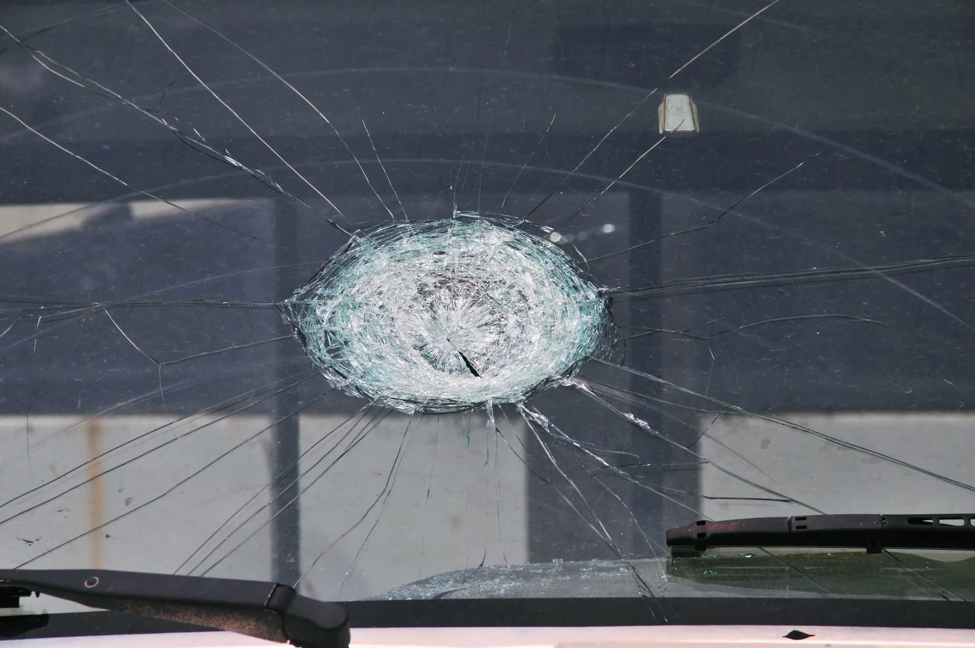 A windshield cracked by a hailstone