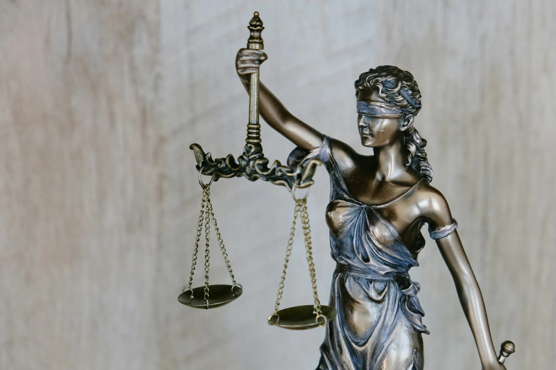 A bronze statue of Lady Justice holding scales