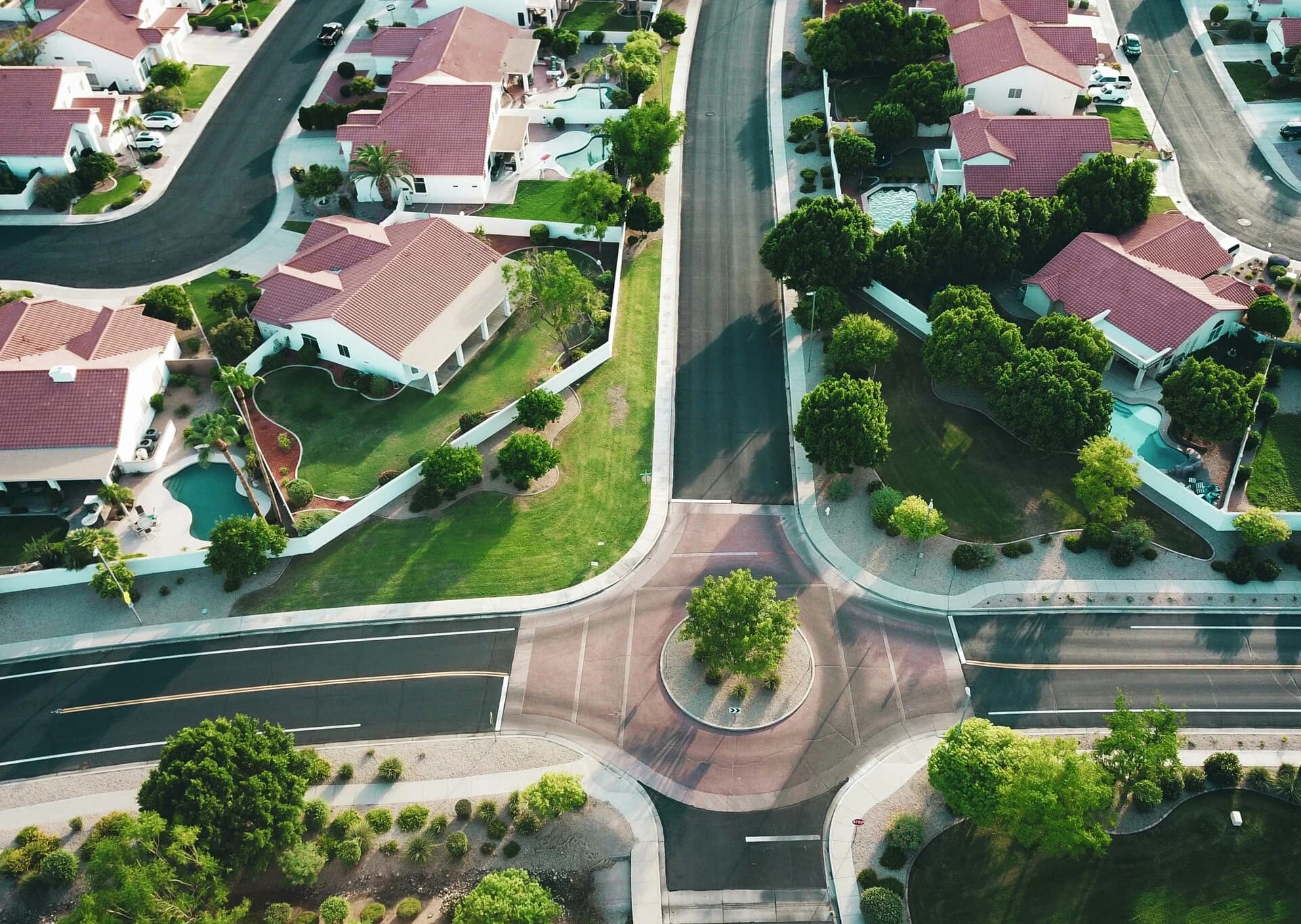 An aerial view of a suburban neighbourhood with red-roofed houses